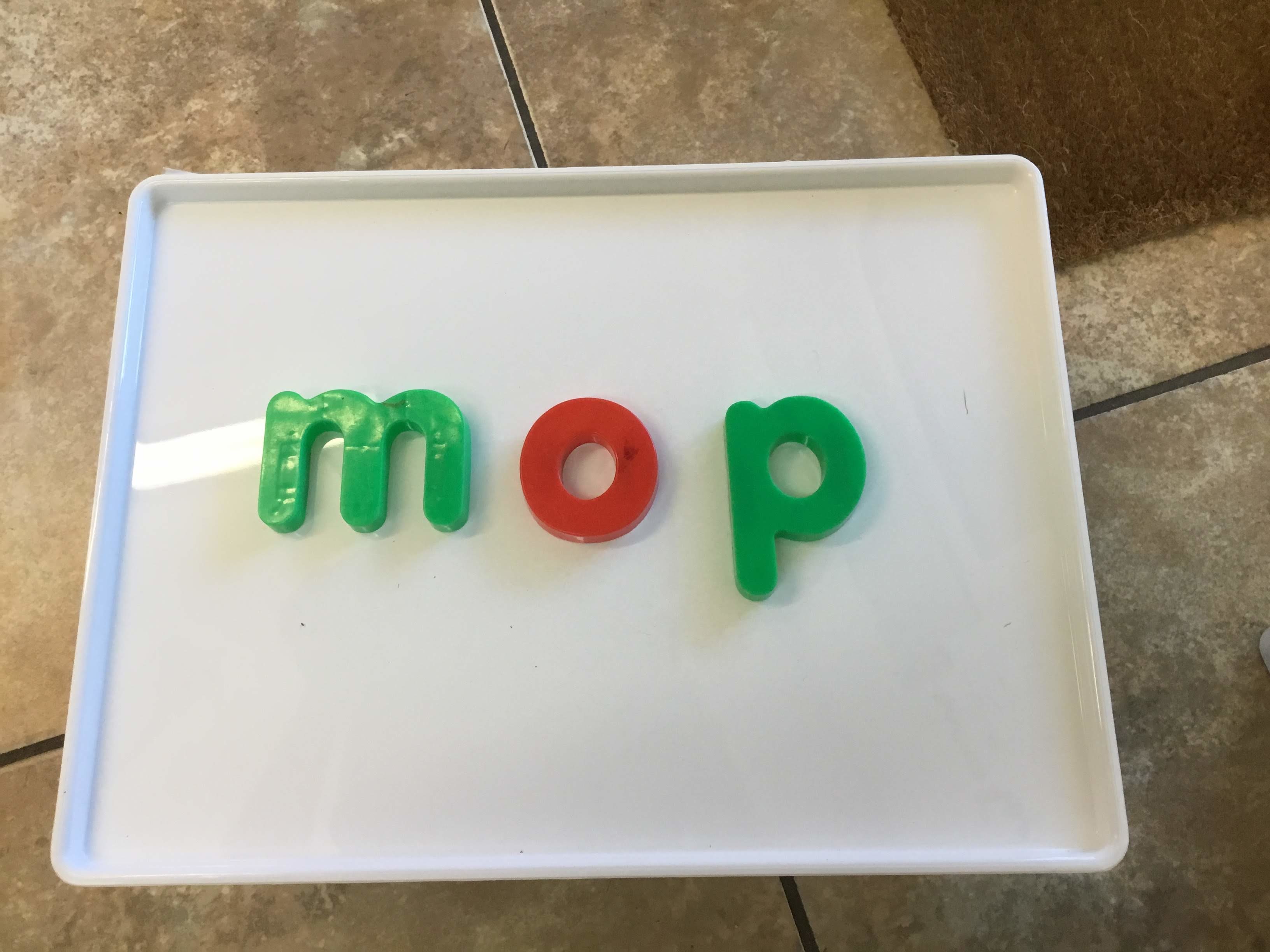 a magnetic tray with letter shaped magnets spelling out the word mop